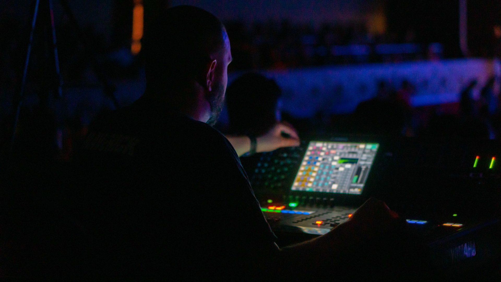 Close view of the console faders during a mix session.